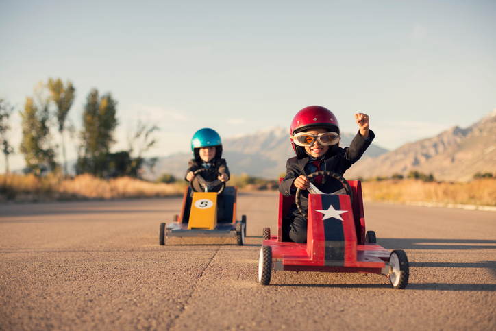 Young Business Boys in Suits Race Toy Cars